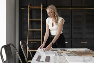 Katie Kurtz creating a mood board with textiles in her Adorned Homes office space in Wayzata, Minnesota.