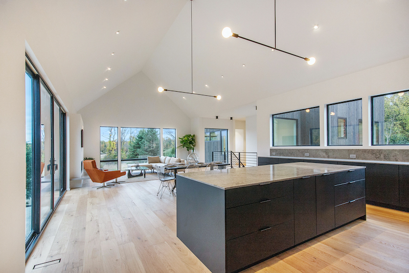 Minimalist kitchen inside Hilltop Farm, a contemporary home by Hygge Custom Homes, featuring Marvin Essential windows and doors.