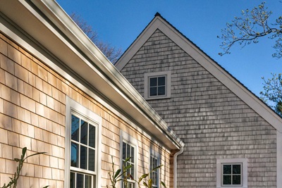 The roof of a traditional home in Massachusetts, featuring Marvin Elevate Awning and Double Hung windows.