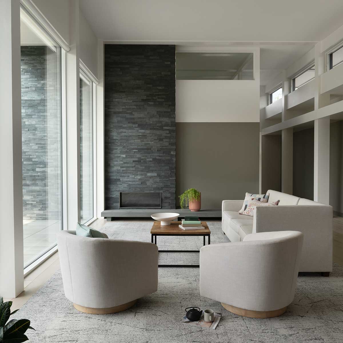 A modern living room featuring Marvin Modern Direct Glaze windows and Modern Awning windows in a home in New Hampshire.