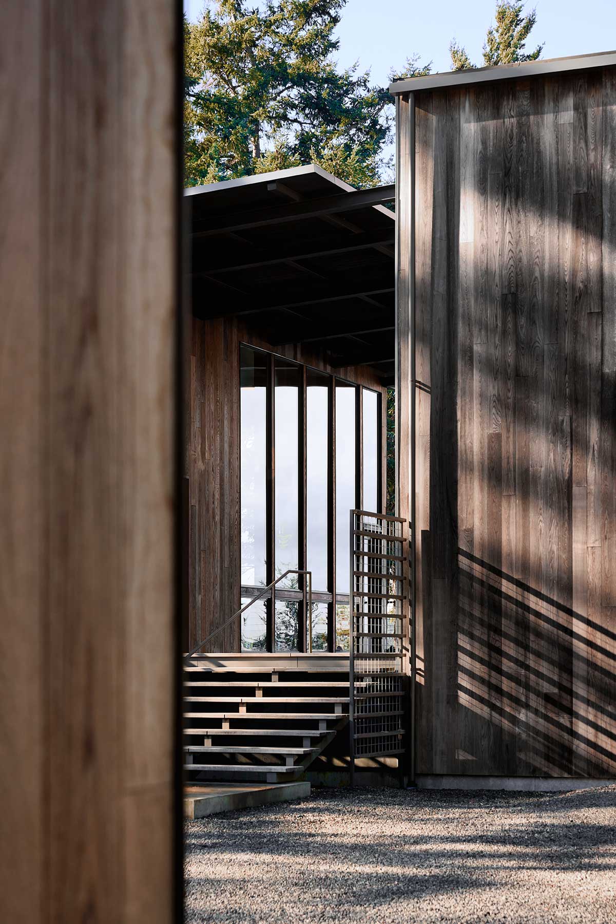 The exterior of a home overlooking Puget Sound, featuring Marvin Ultimate Direct Glaze windows.