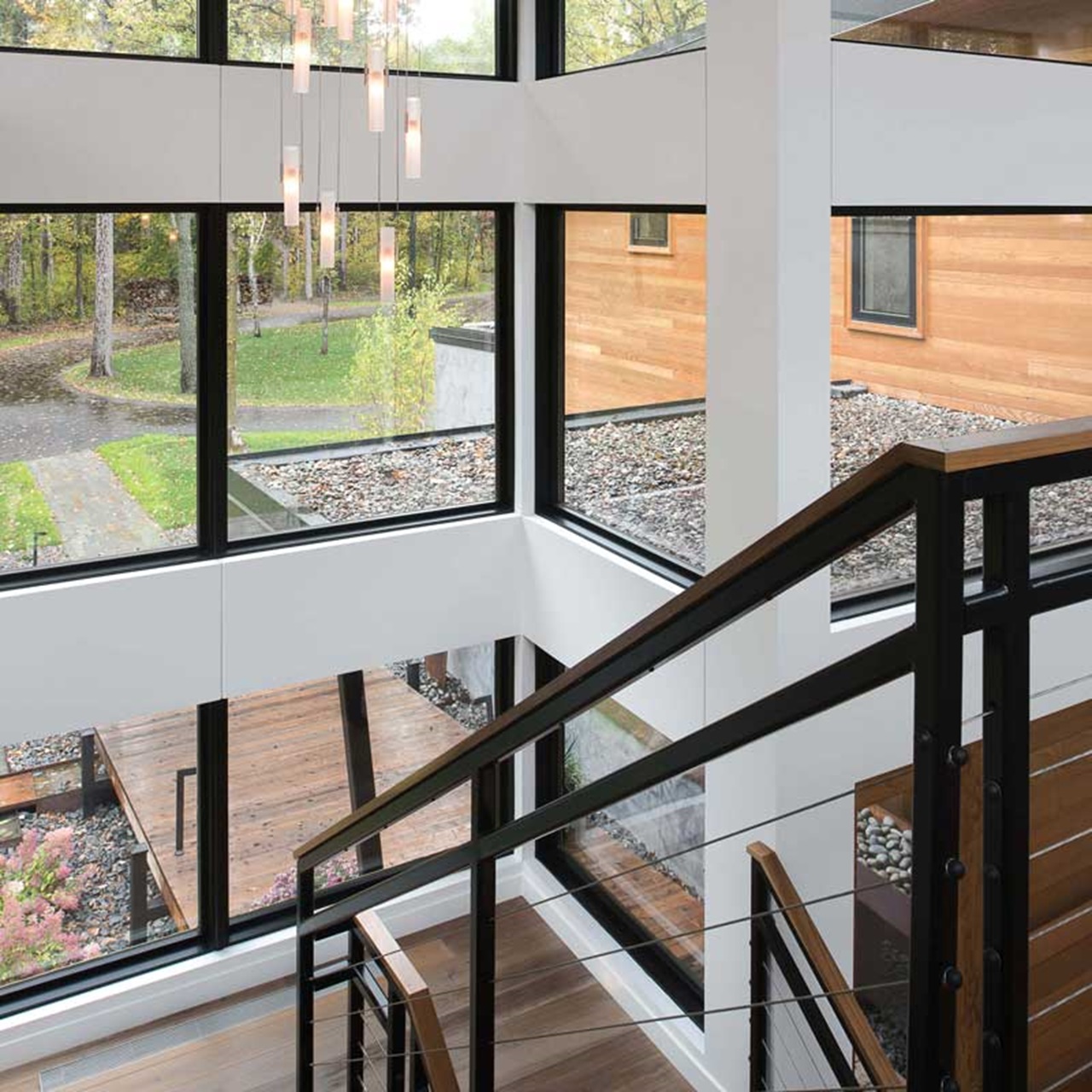 Large Stairwell Surrounded By Signature Ultimate Picture Narrow Frame Windows