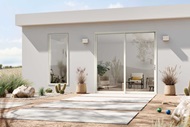 The exterior of a white modern home with a Marvin Essential Sliding patio door